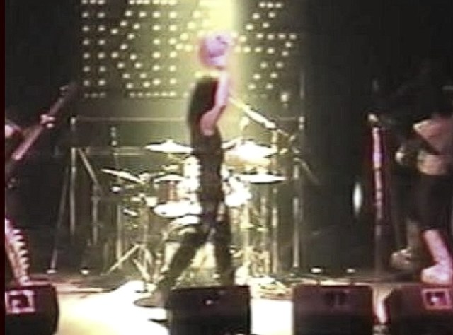 Vintage concert video still from a stage performance