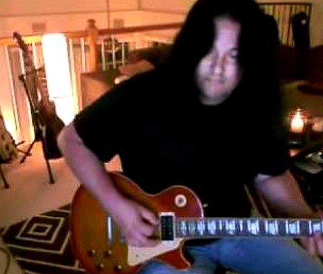 Benny Doro playing guitar at home