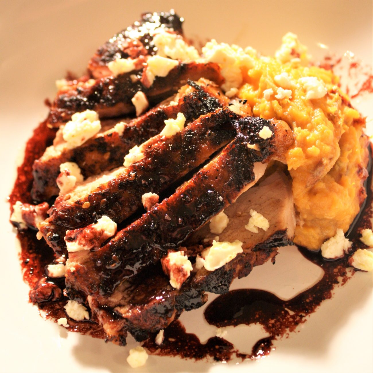Smoked Pork chop with red wine bernaise and goat feta